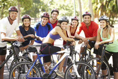 Group Of Cyclists Resting During Cycle Ride Through Parkの写真素材