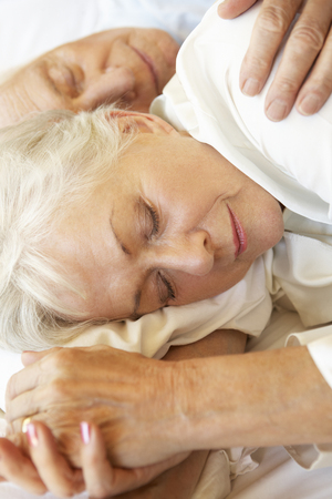 Senior Couple Sleeping In Bedの写真素材