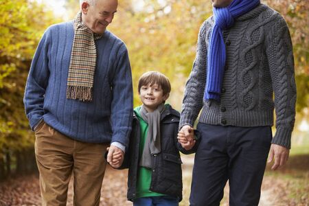 Male Multl Generation Family Walking Along Autumn Pathの写真素材