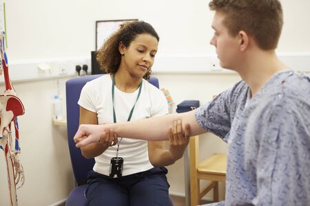 Male Patient Having Physiotherapy In Hospital