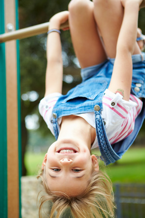 Young Girl On Climbing Frame In Playgroundの写真素材