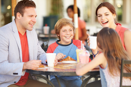 Family Enjoying Snack In Cafの写真素材