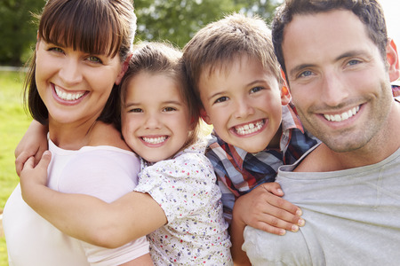 Parents Giving Children Piggybacks Outdoorsの写真素材