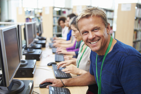 Group Of Mature Students Working At Computers