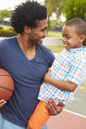 Father With Son Playing Basketball In Park Togetherの写真素材