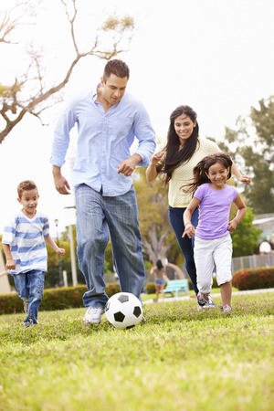 Hispanic Family Playing Soccer Togetherの写真素材