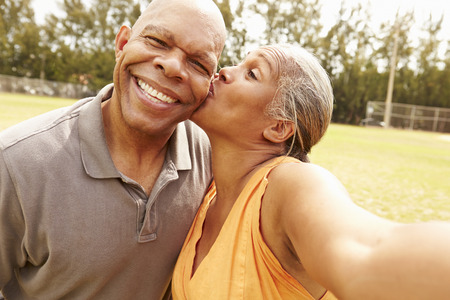 Romantic Senior Couple Taking Selfie In Parkの写真素材