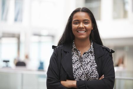 Head And Shoulders Portrait Of Young Businesswoman In Office