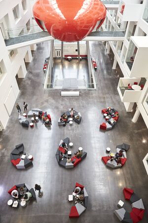 Seating in the atrium of modern university building, verticalの写真素材