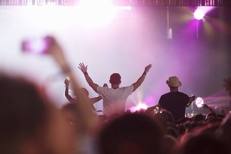 Fans Sitting On Friend's Shoulders At Music Festivalの写真素材