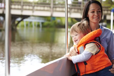 Mother And Son Enjoying Day Out In Boat On River Togetherの写真素材