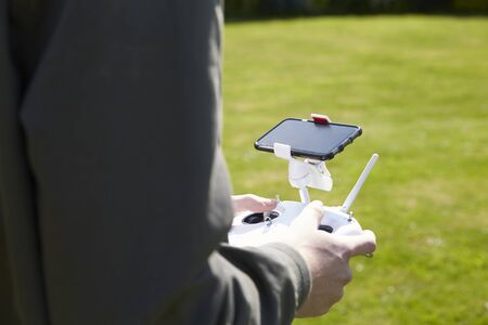 Close Up Of Man Flying Drone Quadcopter In Garden