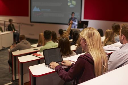 Adult student using laptop computer at a university lectureの写真素材