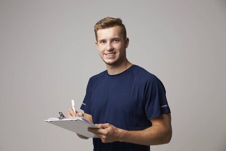 Studio Portrait Of Male Sports Coach With Clipboardの写真素材