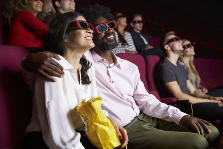 Couple In Cinema Wearing 3D Glasses Watching Comedy Film