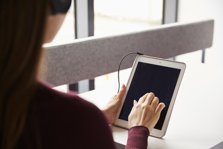 View Over The Shoulder Of Female Student With Digital Tablet