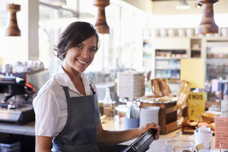 Portrait Of Female Employee Working At Delicatessen Checkoutの写真素材