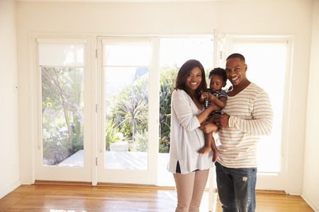 Portrait Of Family In New Home On Moving Dayの写真素材