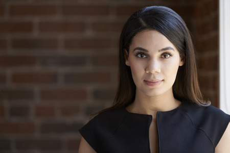 Head And Shoulders Portrait Of Young Businesswoman In Officeの写真素材