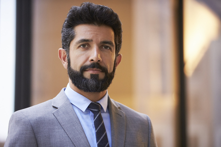 Middle aged Hispanic businessman looking to cameraの写真素材