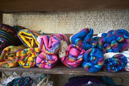 Colourful blankets on shelves in store, close up, front viewの写真素材