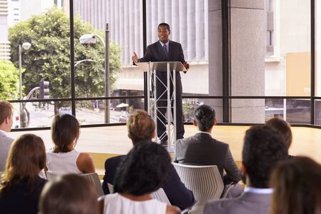 Black businessman presenting business seminar to an audienceの写真素材
