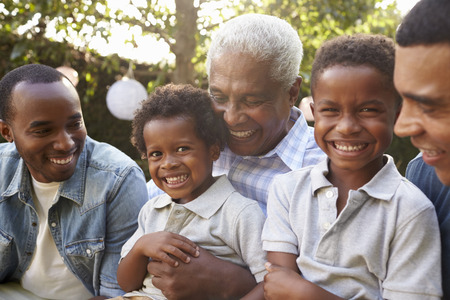 Multi generation male family members gathered in a gardenの写真素材