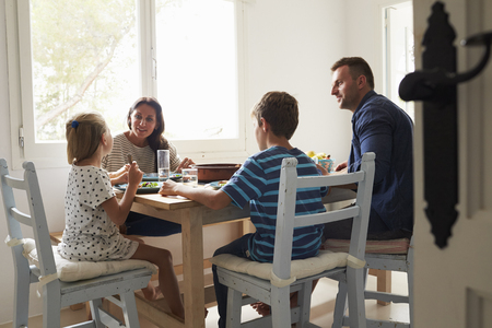 Family At Home In Eating Meal Togetherの写真素材