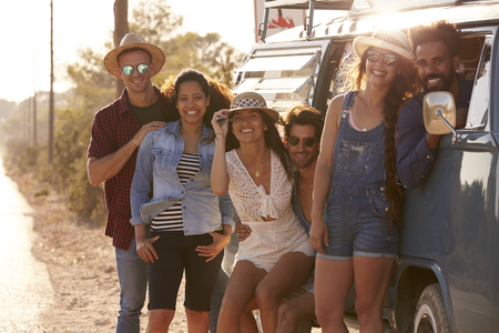 Friends travelling in a camper van make a roadside stopの写真素材