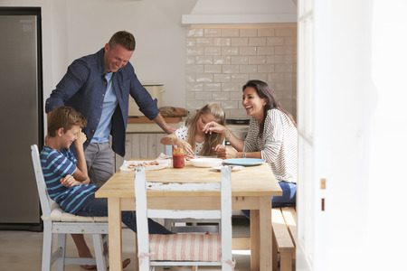 Family At Home In Kitchen Making Pizzas Togetherの写真素材