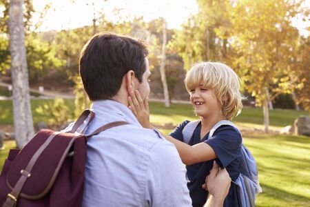 Father Fastening Son's Backpack As They Get Ready For Hikeの写真素材