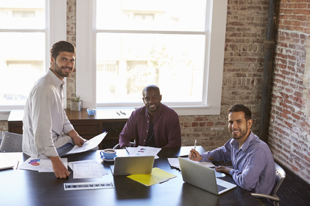 Portrait Of Businessmen Working Together In Boardroomの写真素材