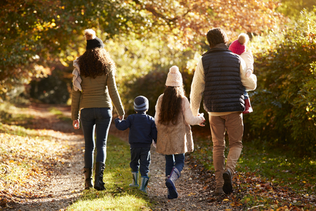 Rear View Of Family Enjoying Autumn Walk In Countrysideの写真素材