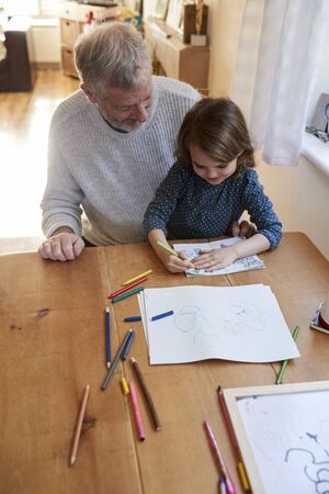Grandfather And Granddaughter Colouring Picture Togetherの写真素材