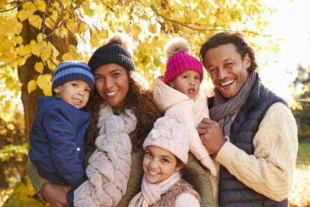 Outdoor Portrait Of Family In Autumn Landscape