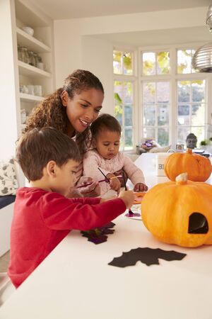 Mother And Children Making Halloween Decorations At Homeの写真素材