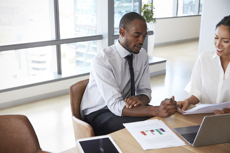 Businesspeople Working On Laptop In Boardroom Togetherの写真素材