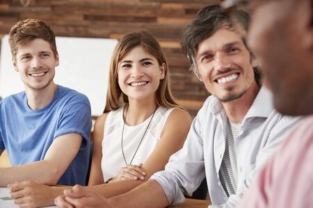 Close up of four happy work colleagues