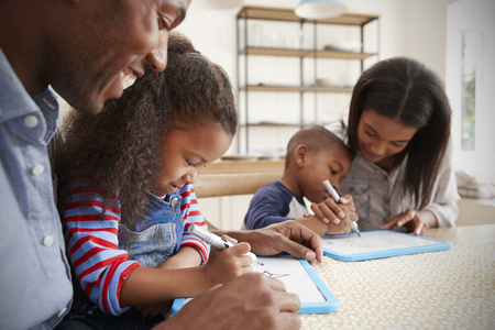 Parents And Children Drawing On Whiteboards At Tableの写真素材