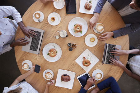 Overhead Shot Of Businesspeople Meeting In Coffee Shopの写真素材