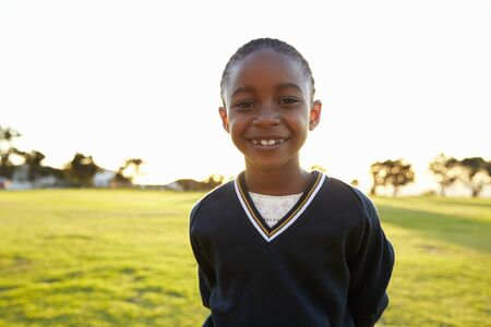 Portrait of African elementary school girl smiling in a parkの写真素材