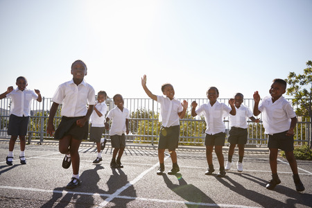 Elementary school kids having fun in school playgroundの写真素材