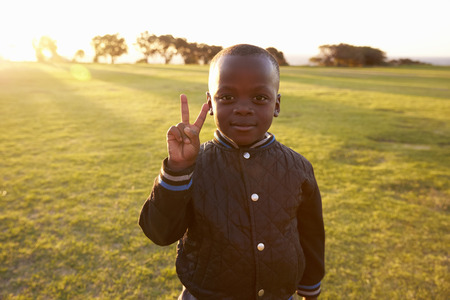 African elementary school boy making peace signの写真素材