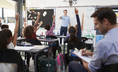 Trainee teacher learning how teach elementary studentsの写真素材