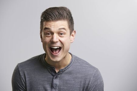 Portrait of a laughing young white man looking to camera