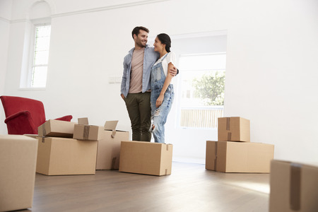 Couple Carrying Boxes Into New Home On Moving Dayの写真素材