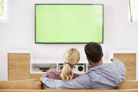 Rear View Of Couple Watching Television Togetherの写真素材