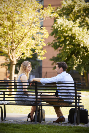 Businessman Talking To Female Colleague On Break In Parkの写真素材