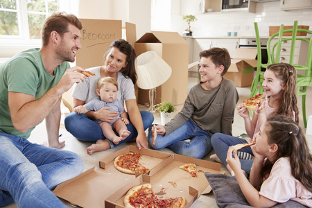Family Celebrating Moving Into New Home With Pizzaの写真素材