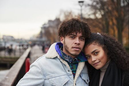 Portrait Of Couple Walking Along South Bank On Visit To London